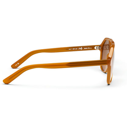 Side profile of amber acetate square sunglasses with brown lenses, featuring 'Judy' branding on the temple arm, set against a plain white background.
