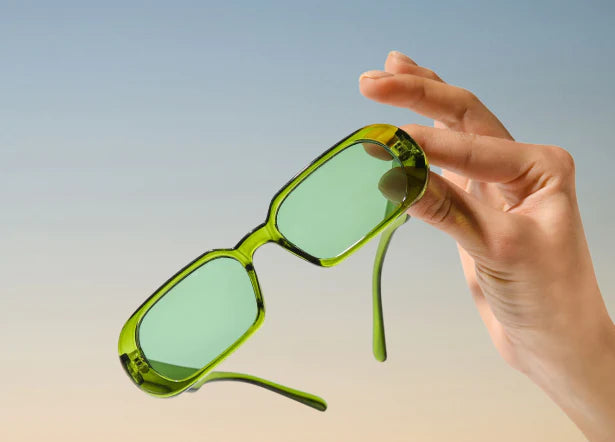 Woman Holding Sunglasses